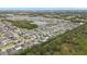 Aerial view of a residential neighborhood with houses and a lake at 12152 Ledbury Commons Dr, Gibsonton, FL 33534