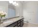 Bathroom with granite countertop, dark brown cabinets and shower at 12152 Ledbury Commons Dr, Gibsonton, FL 33534