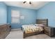 Cozy bedroom with light blue walls, a comfortable bed, and plenty of storage at 12152 Ledbury Commons Dr, Gibsonton, FL 33534