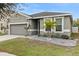 Two-story house with gray siding, two-car garage, and landscaped yard at 12152 Ledbury Commons Dr, Gibsonton, FL 33534