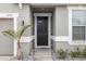 Modern black front door with sidelights and landscaping at 12152 Ledbury Commons Dr, Gibsonton, FL 33534