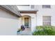 Inviting front entrance with a teal door, stone pathway, and lush landscaping at 1237 N Mcmullen Booth Rd # 1237, Clearwater, FL 33759