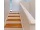 Wooden staircase with white risers and railing at 1237 N Mcmullen Booth Rd # 1237, Clearwater, FL 33759