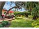 Landscaped backyard with deck and seating at 1320 Fairway Dr, Dunedin, FL 34698