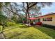 Sunny backyard with deck and patio furniture at 1320 Fairway Dr, Dunedin, FL 34698