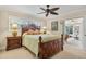 Comfortable bedroom with wood bed frame and access to sunroom at 1320 Fairway Dr, Dunedin, FL 34698