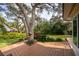 Deck nestled under large shade trees at 1320 Fairway Dr, Dunedin, FL 34698