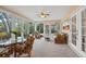 Relaxing sunroom featuring wicker furniture and backyard access at 1320 Fairway Dr, Dunedin, FL 34698