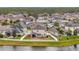 Aerial view of house and neighborhood with lake at 13355 Orca Sound Dr, Riverview, FL 33579