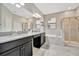 Double vanity bathroom with granite countertops and a large shower at 13355 Orca Sound Dr, Riverview, FL 33579