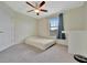 Well lit bedroom with a bed and carpet flooring at 13355 Orca Sound Dr, Riverview, FL 33579