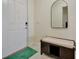 Bright entryway with white door, bench, and a mirror at 13355 Orca Sound Dr, Riverview, FL 33579