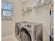 Bright laundry room featuring a washer and dryer at 13355 Orca Sound Dr, Riverview, FL 33579