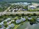 Aerial view of the community with nearby amenities and a lake at 1344 Pine Ridge E Cir # D2, Tarpon Springs, FL 34688