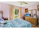 Bright bedroom with a double bed, dresser, and window coverings at 1344 Pine Ridge E Cir # D2, Tarpon Springs, FL 34688