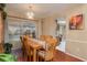 Bright dining room with wooden table and view of kitchen at 14315 Arbor Hills Rd, Tampa, FL 33625