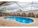 Relaxing kidney-shaped pool with screened enclosure at 14315 Arbor Hills Rd, Tampa, FL 33625