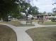 Community bocce ball court with benches under large shade trees at 1515 Forrest Nelson Blvd # E108, Port Charlotte, FL 33952