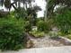 Landscaped front yard with lush greenery and rock garden at 1515 Forrest Nelson Blvd # E108, Port Charlotte, FL 33952