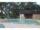 Community pool with surrounding patio furniture and shaded seating area at 1515 Forrest Nelson Blvd # E108, Port Charlotte, FL 33952