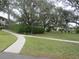 Paved walkway meandering through manicured lawns and landscaping at 1515 Forrest Nelson Blvd # E108, Port Charlotte, FL 33952