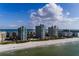 Aerial view of beachfront condo buildings with swimming pool and tennis courts at 1520 Gulf Blvd # 1404, Clearwater Beach, FL 33767