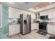 Modern kitchen with stainless steel appliances and white cabinets at 1520 Gulf Blvd # 1404, Clearwater Beach, FL 33767