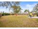 Spacious backyard with grassy area, fire pit, and play area at 1610 Allenton Ave, Brandon, FL 33511