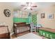 Bedroom with crib, rocker, and safari-themed decor at 1610 Allenton Ave, Brandon, FL 33511