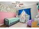 Charming bedroom with a floral accent wall and twin-size bed at 1610 Allenton Ave, Brandon, FL 33511