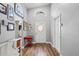 Bright entryway with wood-look floors, featuring a red school desk and decorative wall art at 1610 Allenton Ave, Brandon, FL 33511