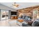 Living room with a wood-look accent wall and sliding doors at 1610 Allenton Ave, Brandon, FL 33511