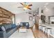 Living room with wood-look wall and open concept to kitchen at 1610 Allenton Ave, Brandon, FL 33511