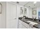 Bathroom with granite countertop and white cabinets at 1660 Gulf Blvd # Ph1, Clearwater Beach, FL 33767