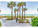 Beach access walkway with palm trees and seating at 1660 Gulf Blvd # Ph1, Clearwater Beach, FL 33767