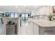 Modern kitchen with white cabinets, marble counters, and ocean views at 1660 Gulf Blvd # Ph1, Clearwater Beach, FL 33767