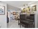 Living room features a piano, gold records, and comfy seating at 1660 Gulf Blvd # Ph1, Clearwater Beach, FL 33767