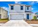 Two-story home with white exterior and attached garage at 17033 Oval Rum Dr, Wimauma, FL 33598