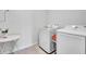 Laundry room with washer, dryer and side table at 17033 Oval Rum Dr, Wimauma, FL 33598