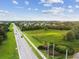 Aerial view of a residential area with roads and greenery at 18442 New London Ave, Land O Lakes, FL 34638