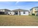 Backyard view of home with patio and lake view at 18442 New London Ave, Land O Lakes, FL 34638