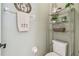 Small bathroom with toilet and shelving unit at 18442 New London Ave, Land O Lakes, FL 34638