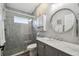 Modern bathroom with grey tile, a walk-in shower, and a floating vanity at 18442 New London Ave, Land O Lakes, FL 34638