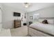 Charming bedroom with a full-size bed, dresser, and mounted TV at 18442 New London Ave, Land O Lakes, FL 34638