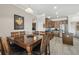 Bright dining area with kitchen view and wood table at 18442 New London Ave, Land O Lakes, FL 34638