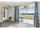 Bright living area with sliding glass doors leading to a patio overlooking a lake at 18442 New London Ave, Land O Lakes, FL 34638