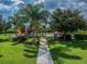 Community playground with playset and palm trees at 18442 New London Ave, Land O Lakes, FL 34638