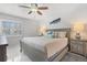 Bright bedroom with a king-size bed and ceiling fan at 19727 Gulf Blvd # 103, Indian Shores, FL 33785