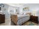 Main bedroom with wood sleigh bed and tiled floors at 204 Sky Loch W Dr, Dunedin, FL 34698