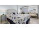 Guest bedroom with seashell bedding and small sitting area at 204 Sky Loch W Dr, Dunedin, FL 34698